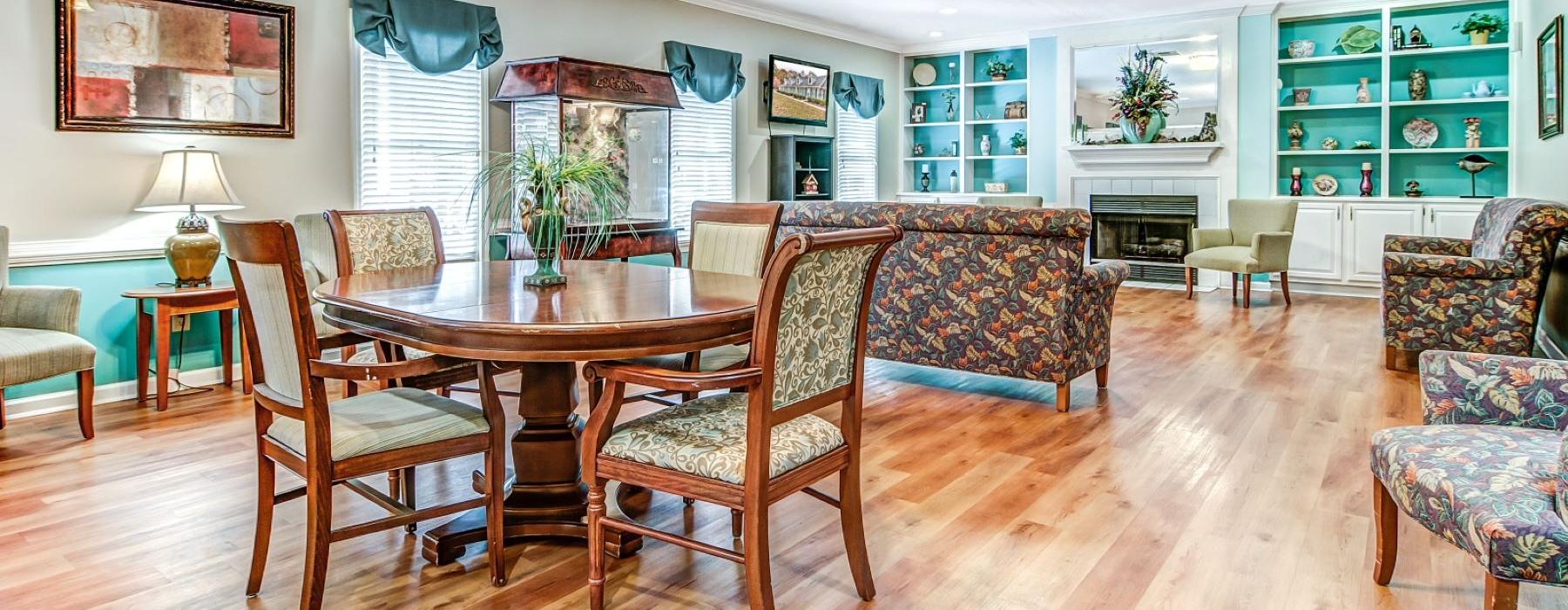 a large living room with a dining table and chairs